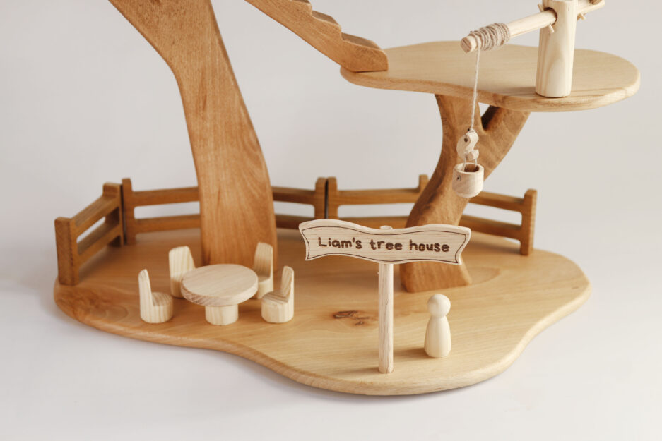 Handcrafted wooden treehouse toy with platforms, stairs, and rope swing, ideal for imaginative play