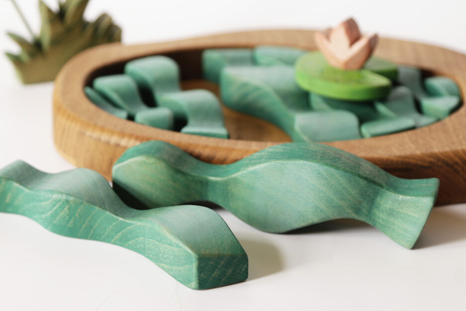 Educational wooden toy for kids – puzzle-like pond scene with smooth, colorful pieces.