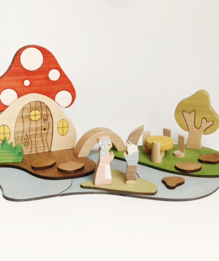 Fairy Tale Mushroom Cottage wooden playscape with gnomes, bridge, tree, and mushroom house.